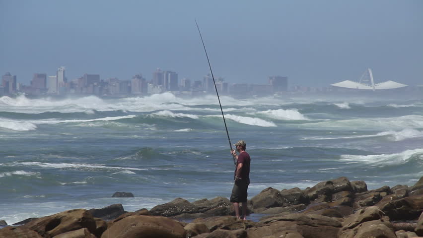 Fisherman with Durban city in the background.