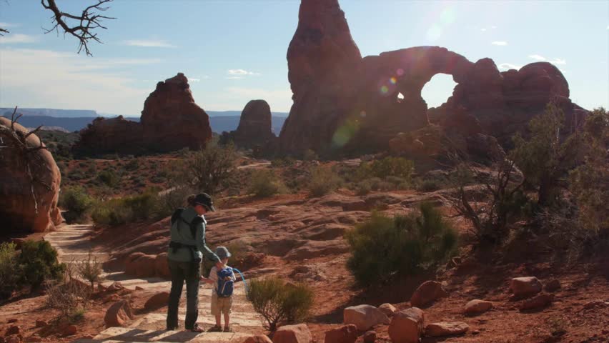 A mother hikes with her kids through Arches National Park in the desert of Southern Utah near Moab