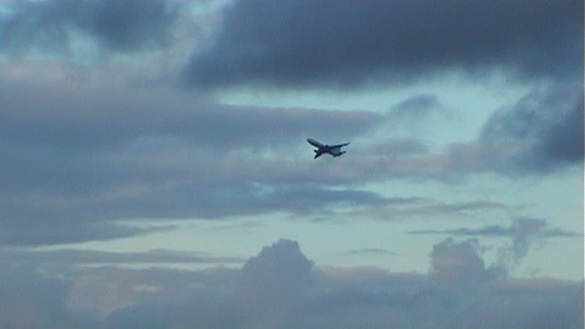 Plane in a sky on sunset, tripod, 16x9