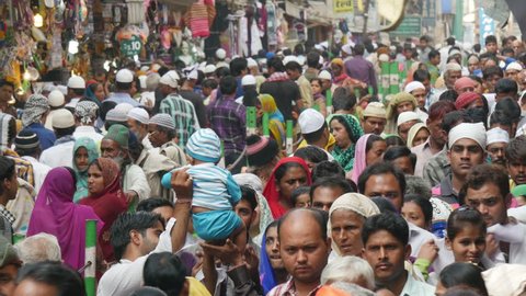 AJMER, INDIA - 30 OCTOBER 2014: Large crowds walk through a busy street towards the Dargah shrine, in Ajmer. Dargah is an important place to visit for Sunni Muslims in India.