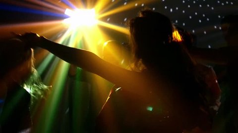 pair of dancers dancing in the spotlight at the club, silhouette,light falls beautifully on their body, Slow motion 