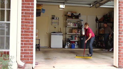  Mature couple working to clean the garage.
