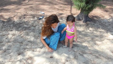baby and mum play sand seashore