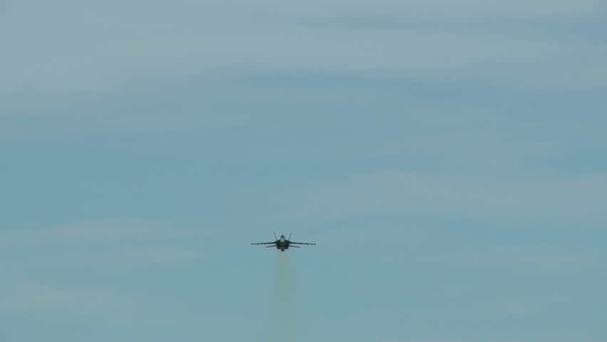 An F18 Hornet in a high speed overhead pass