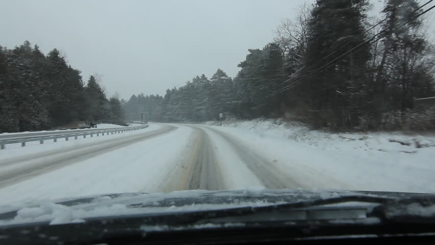 Snowstorm drive in the country. Going around a corner. Driving on Highway 7 just west of Rockwood, Ontario, Canada. Royalty-Free Stock Footage #9489911
