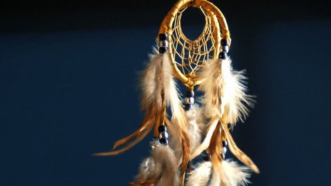 Native American dreamcatcher blowing in breeze at night