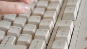 Business woman typing on old style keyboard keys close-up slow tilting 4K 2160p UltraHD footage - Female fingers over retro beige keyboard keys typing 4K 3840X2160 UHD video