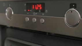 Modern kitchen stove selective focus on temperature dials while programing for cooking 4K 2160p UltraHD footage - Cooking contemporary oven setting temperature and program 4K 3840X2160 UHD video