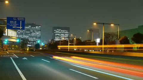 Timelapse of midnight traffic and street illumination surrounding Tokyo's industrial areas.
