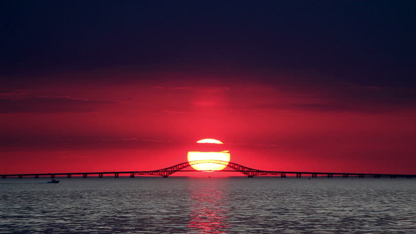 Big Red Sun Setting Over Bridge - Time Lapse