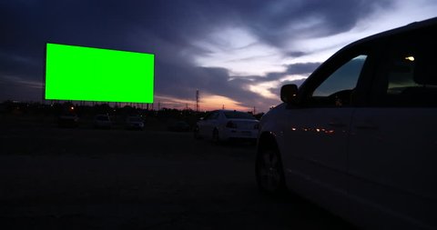 Drive-in movie theater at dusk with green screen -- fill it with anything you want!
