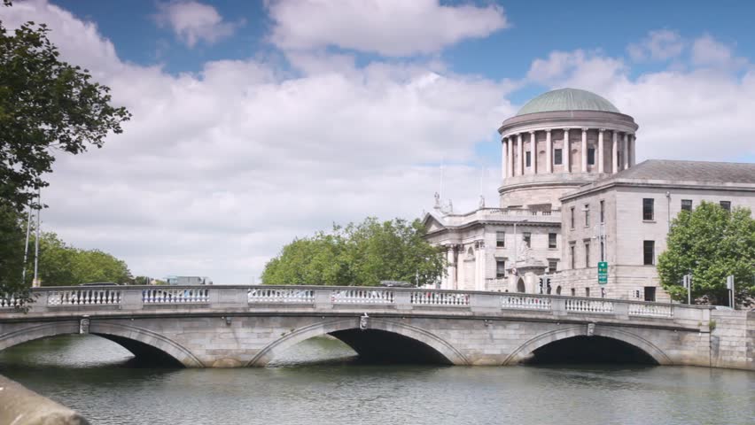 Four Courts and bridge across River Liffey in Dublin on cloudy day
