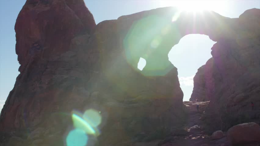 Tourists looking at turret and north window arch in arches national park in southern Uah near Moab