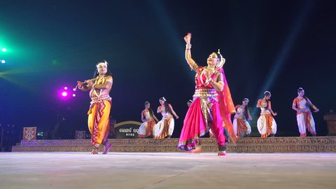 KONARK, INDIA - 3 DECEMBER 2014: Dancers wearing traditional dresses hold a classic performance on stage, during the Konark Dance Festival in India.