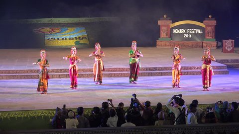 KONARK, INDIA - 3 DECEMBER 2014: Dancers wearing traditional dresses hold a classic performance on stage, during the Konark Dance Festival in India.