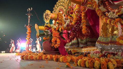 KONARK, INDIA - 3 DECEMBER 2014: Dancers on stage behind colorful deities, depicting Hindu gods, during the Konark Dance festival.