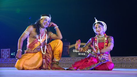 KONARK, INDIA - 3 DECEMBER 2014: Two unidentified dancers play a classic Indian love story on stage during the Konark Dance Festival.