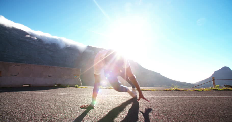 Teenager practicing some flexible breakdancing in a road in slow motion