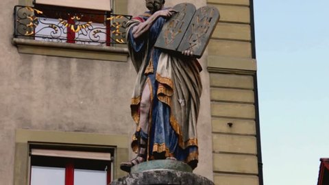 Moses with the Tablets of the Testament - sculpture mounted on the drinking fountain column  at the entrance to the Cathedral city of Bern, Switzerland