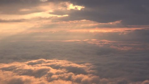 Inside cloud layers with streaming rays of light. Early light 4K clouds with sunrise.