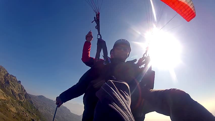 Tandem paragliding over rocky mountains | Shutterstock HD Video #9527612