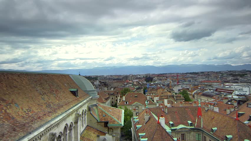 Geneva, Switzerland - July 2014: Fast Motion Time-Lapse from a rooftop overlooking the skyline of the city of Geneva 2014.