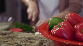 4k Beautiful Woman cooking and chopping vegetables in her kitchen, slow motion, stock video clip.