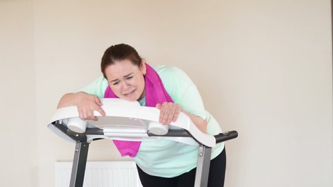 Fat woman running with perseverance on a treadmill
