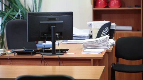 Office desk with computer, telephones and papers. Camera review, nobody