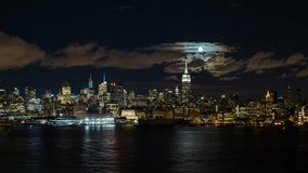 New York - CIRCA NOVEMBER 2014: Moonrise over the Empire State Building and Midtown Manhattan looking across the Hudson River, New York, United States of America, time-lapse - Powered by Shutterstock - Get 15% off with code: PIKWIZARD15