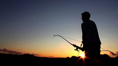 Archery silhouette, sun sets behind the archer