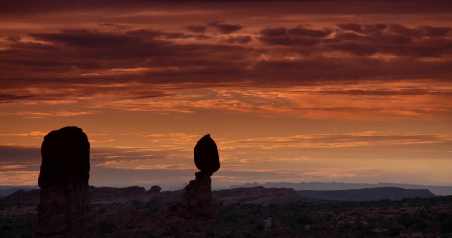 Arches National Park, Moab Utah.  Balanced Rock silhouetted against gorgeous red sunset clouds.