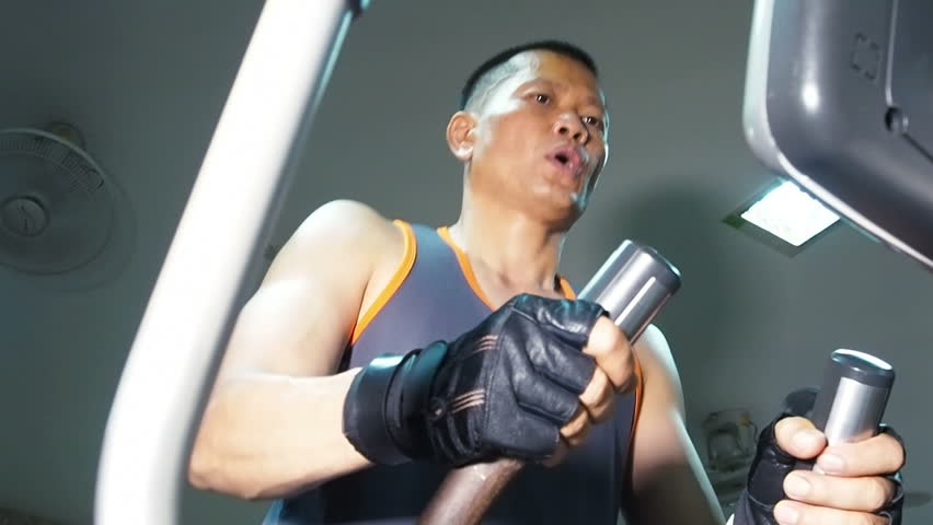 Exercising in the gym,Man tired after finishing on treadmill,Slow motion.
