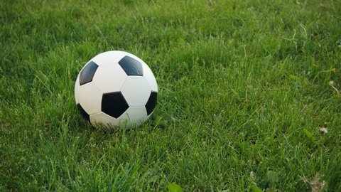 UHD video - Soccer ball on the field with natural grass