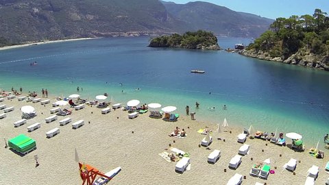 Flying over the beach at mediterranean coast of Turkey. Blue Lagoon and Oludeniz Beach at Fethiye 
