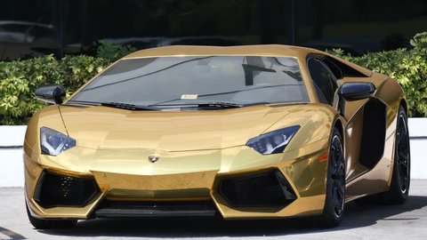 MIAMI - APRIL 6: 4k video of a gold Lamborghini for sale at a car dealership. Lamborghini is an Italian luxury sports car manufacturer April 6, 2015 in Miami FL