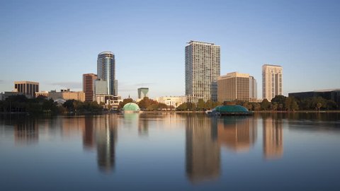 ORLANDO, FL, USA - OCT 30, 2014: 4K Time lapse Orlando Lake Eola in the morning with urban skyscrapers and clear blue sky.