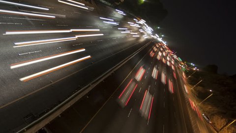 Time lapse rotate and zoom out night motion light trails on a busy Los Angeles freeway