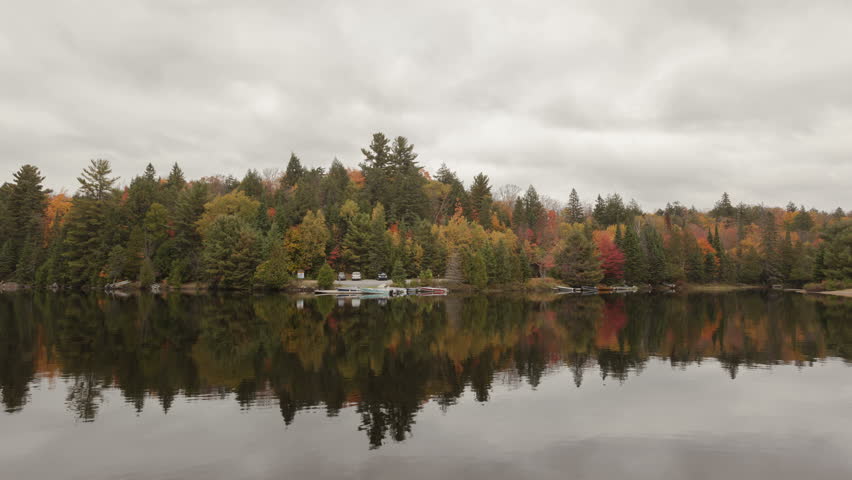 4K Time lapse fall colors at a lake with clouds passing by in Algonquin Provincial park, Ontario, Canada