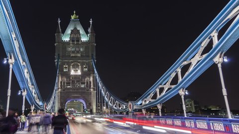 LONDON, ENGLAND, UK - SEP 7,2014: 4K Time lapse Tower Bridge in London, UK illuminated at night with light trails from passing traffic and tourists taking pictures