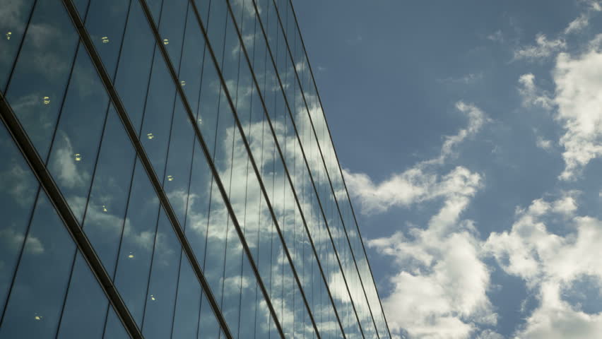 Moving clouds reflect onto office windows
Time lapse of clouds reflecting onto the glass of a large office building. Royalty-Free Stock Footage #9565640