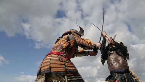 fight two Japanese samurai in the background of sky with clouds closeup