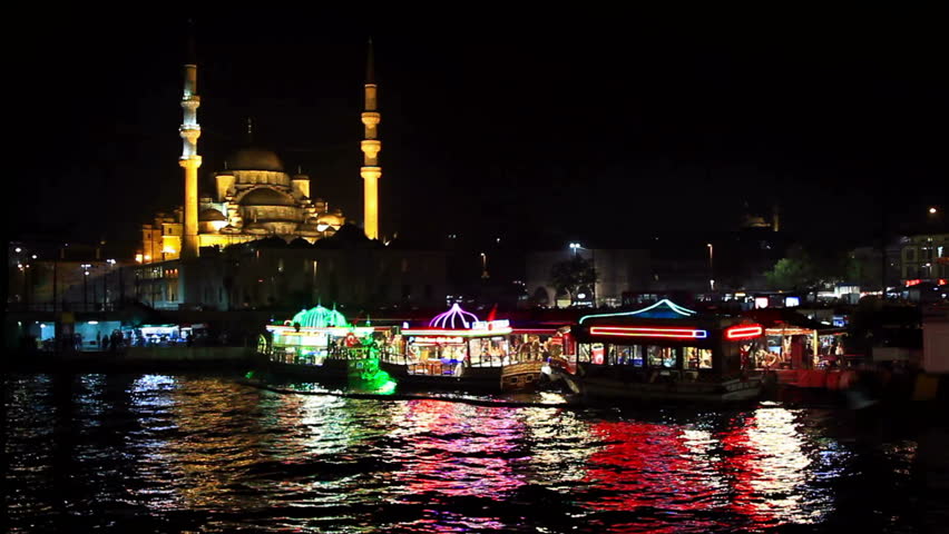 Street vendors cook and sell fish food on colorful boats at Golden Horn coast in