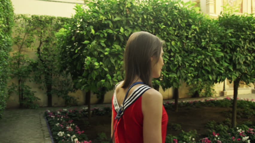 Woman walking and sightseeing Alcazar in Seville, Spain
