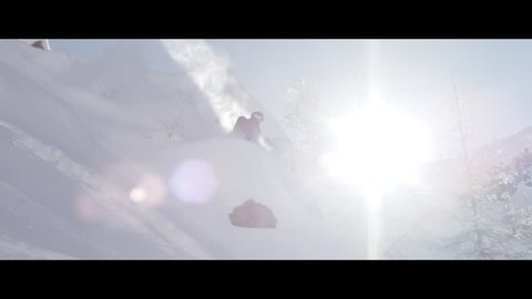 A freestyle skier charges through the powder snow in slow motion