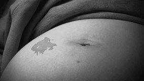 Black and White Close up Video of Pregnant Mother's Belly