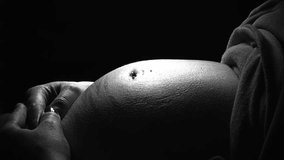 Black and White Close up Video of Pregnant Mother's Belly