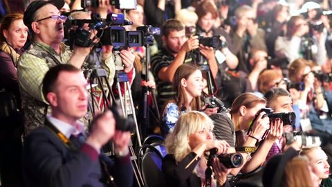 MOSCOW, RUSSIA - MARCH 26, 2015: Photographers crowd shoot models on a catwalk during Moscow Fashion Week in Gostiny Dvor.