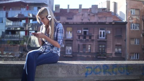 Woman listening music from smart phone mp3 player
