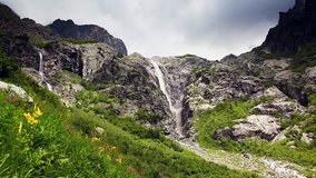 Powerful waterfall at the foot of Mt. Ushba. Upper Svaneti, Georgia, Europe. The main Caucasus ridge. Dramatic unusual scene. Beauty world. HD video (High Definition)